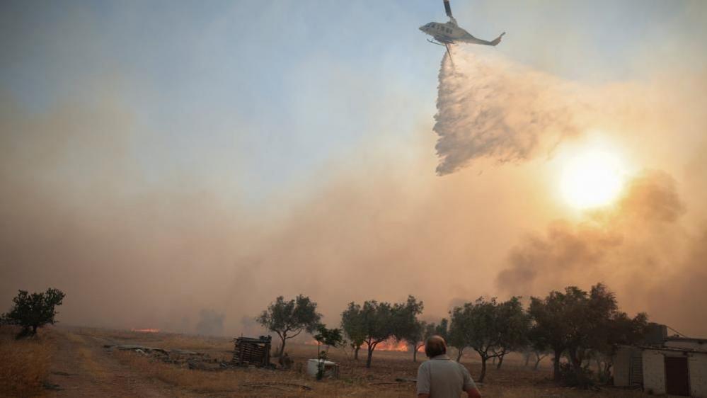Helicopters collide while battling Greek wildfires, crew injured